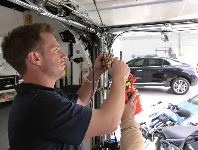 Winchester Garage Door Repair safety certified technician performing cable replacement in Winchester